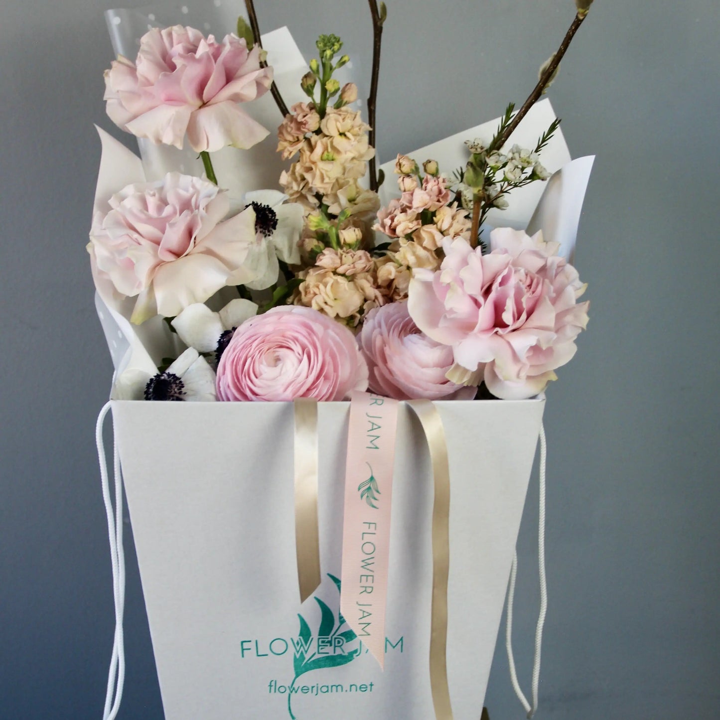 Bouquet of ranunculus, anemones, garden roses, mathiola, and delicate spring branches