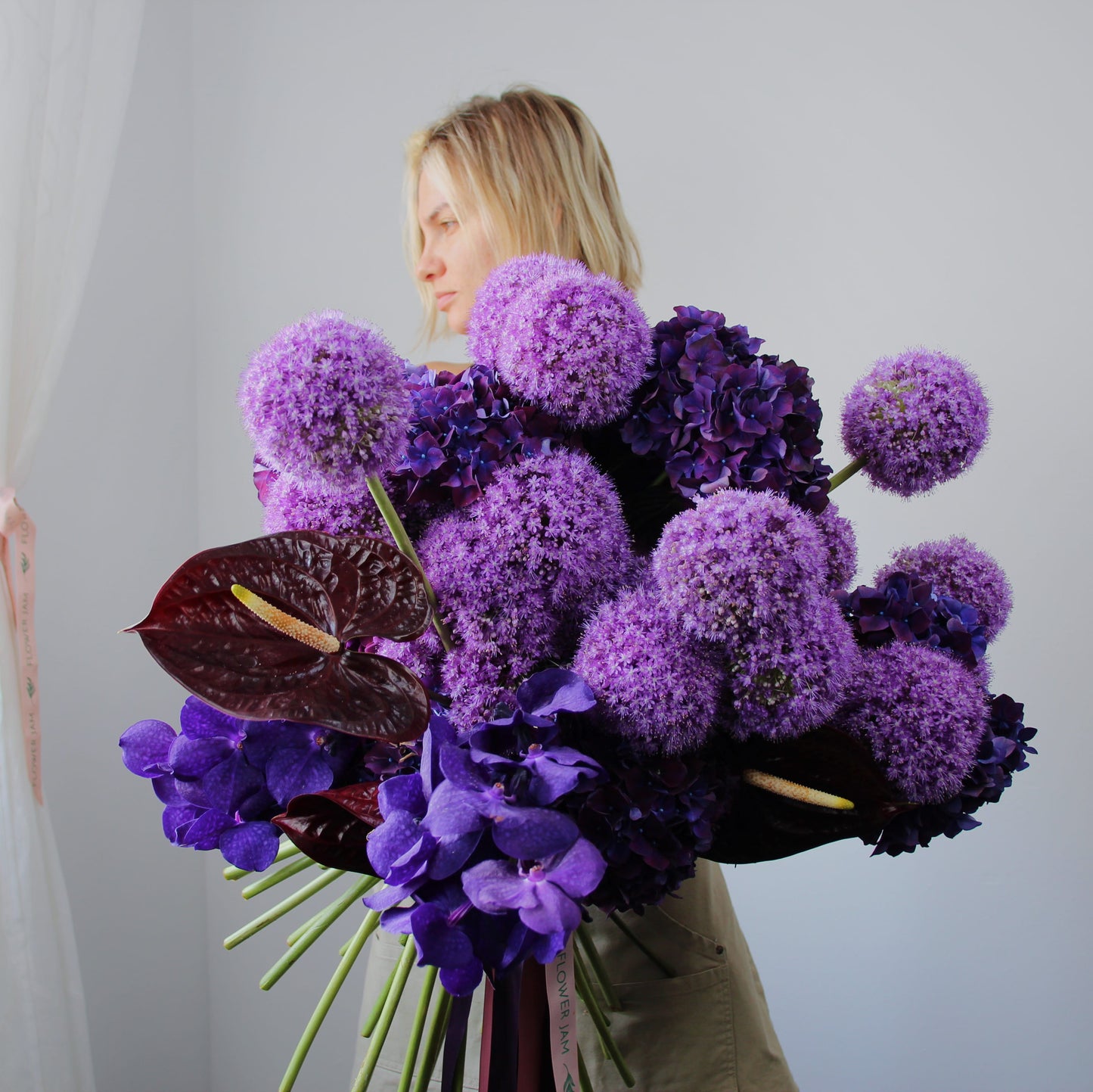 blonde girl with purple flowers bouqet