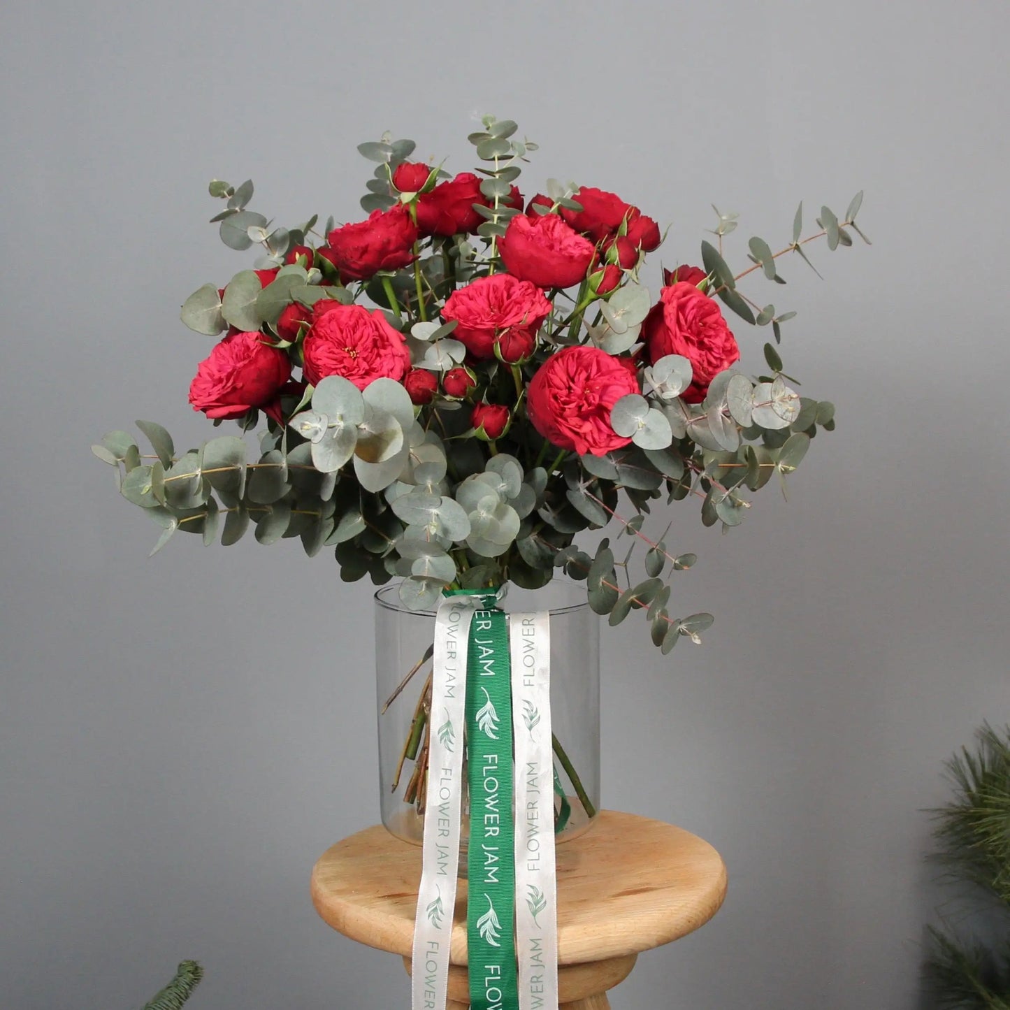 a bouquet of red english garden roses and eucalipt