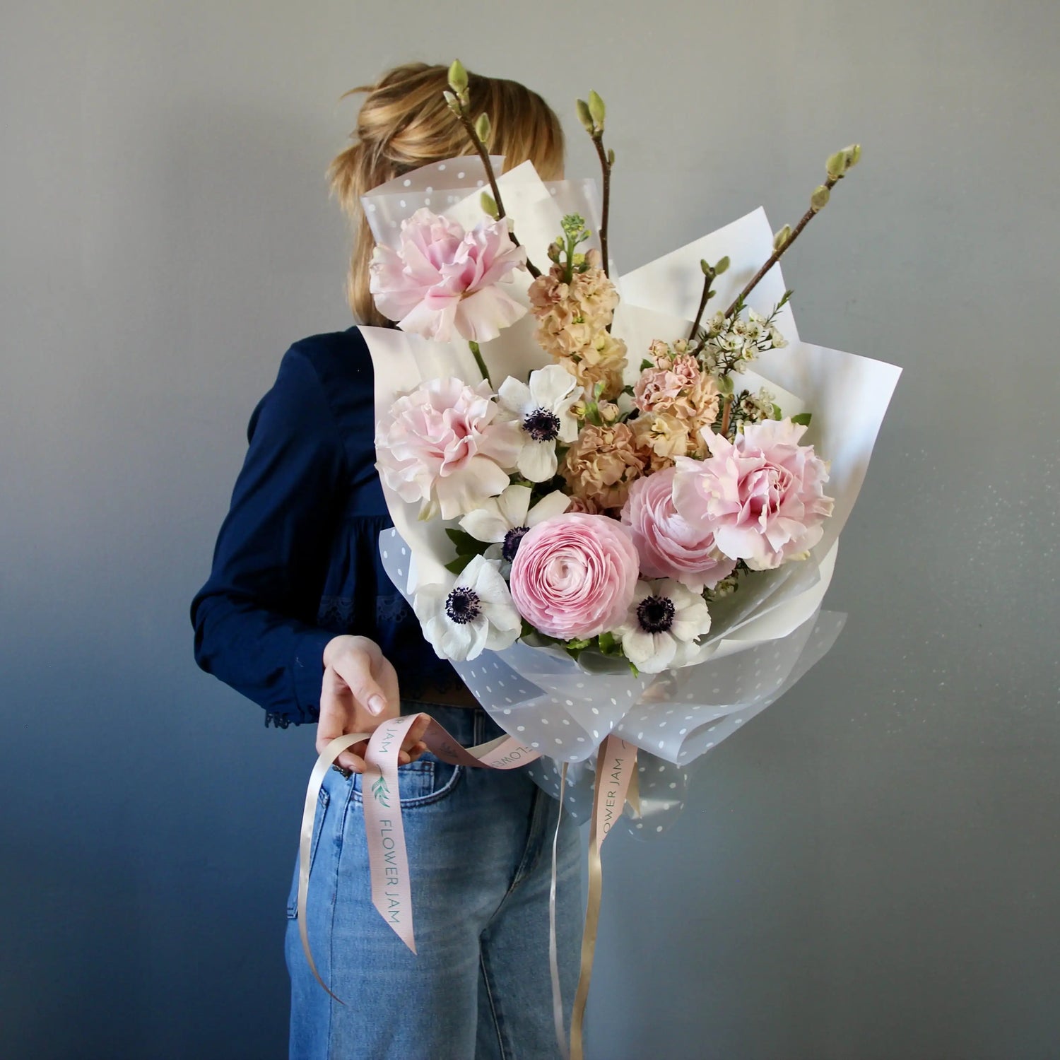 Bouquet of ranunculus, anemones, garden roses, mathiola, and delicate spring branches