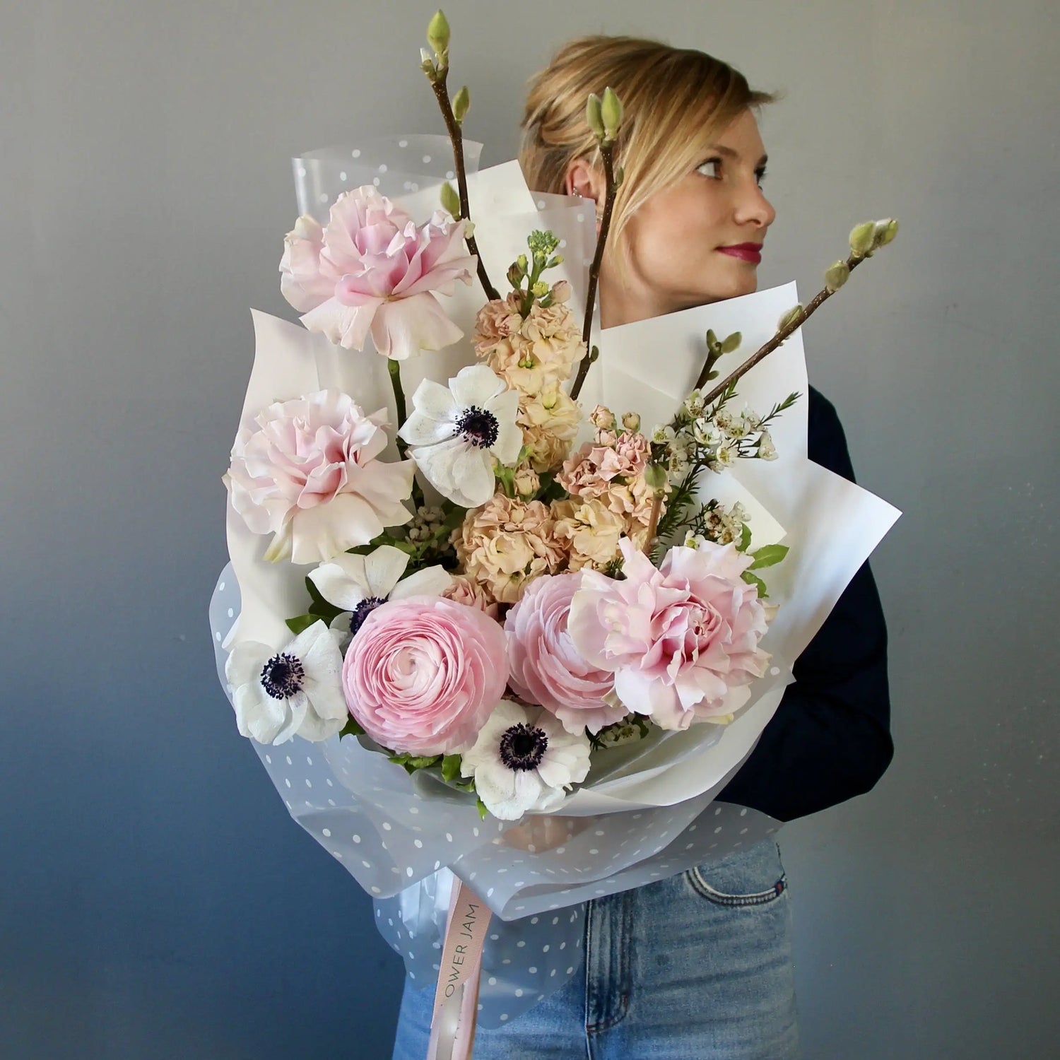 Bouquet of ranunculus, anemones, garden roses, mathiola, and delicate spring branches