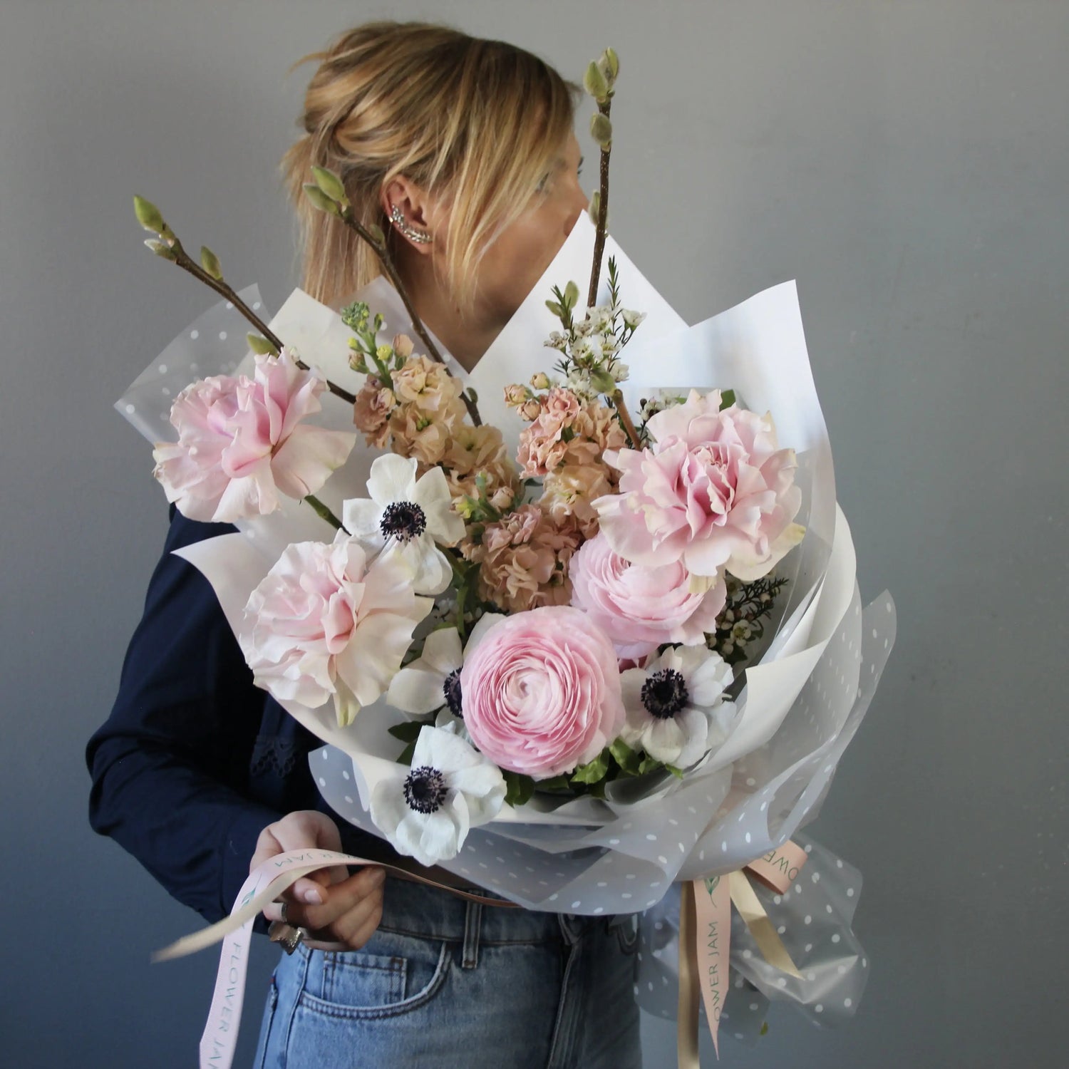 Bouquet of ranunculus, anemones, garden roses, mathiola, and delicate spring branches