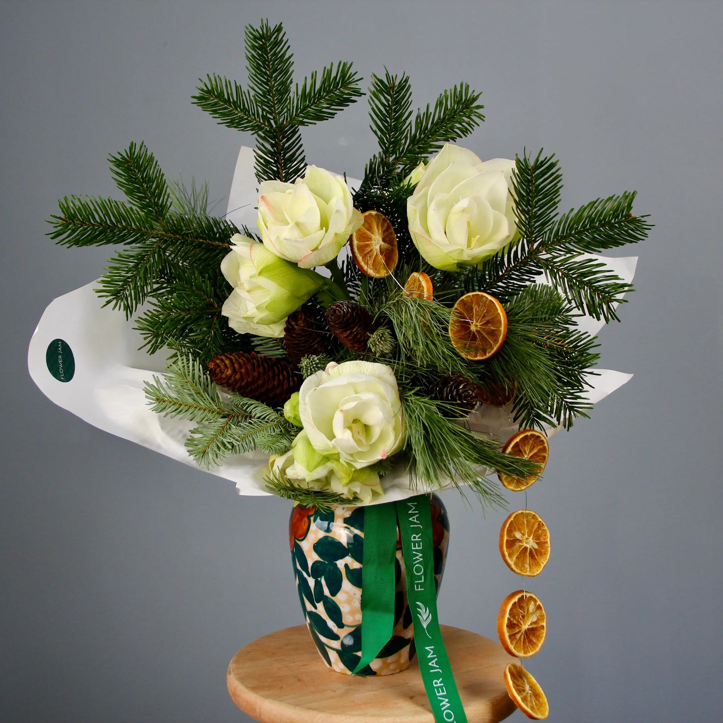 bouquet of spruce branches, white flowers, and oranges