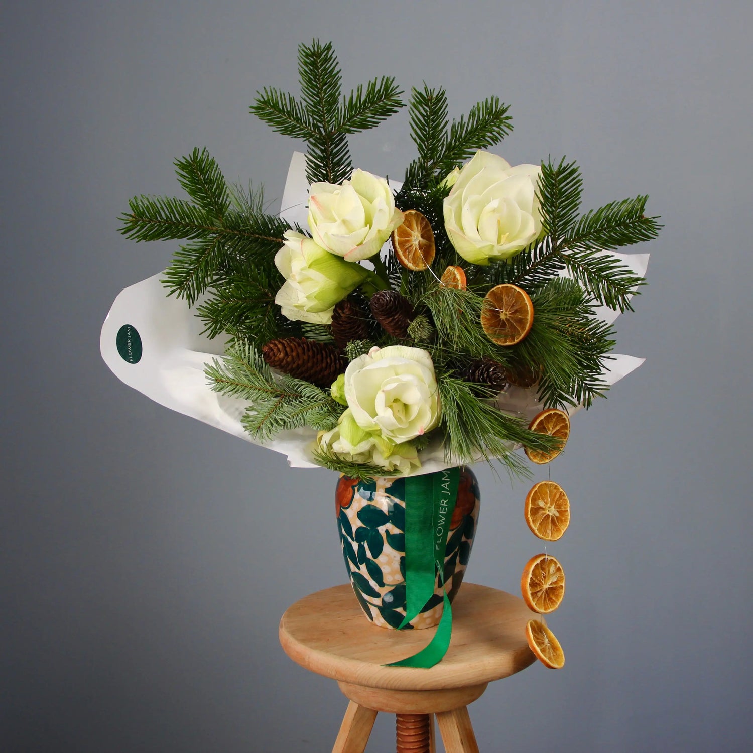 bouquet of spruce branches, white flowers, and oranges