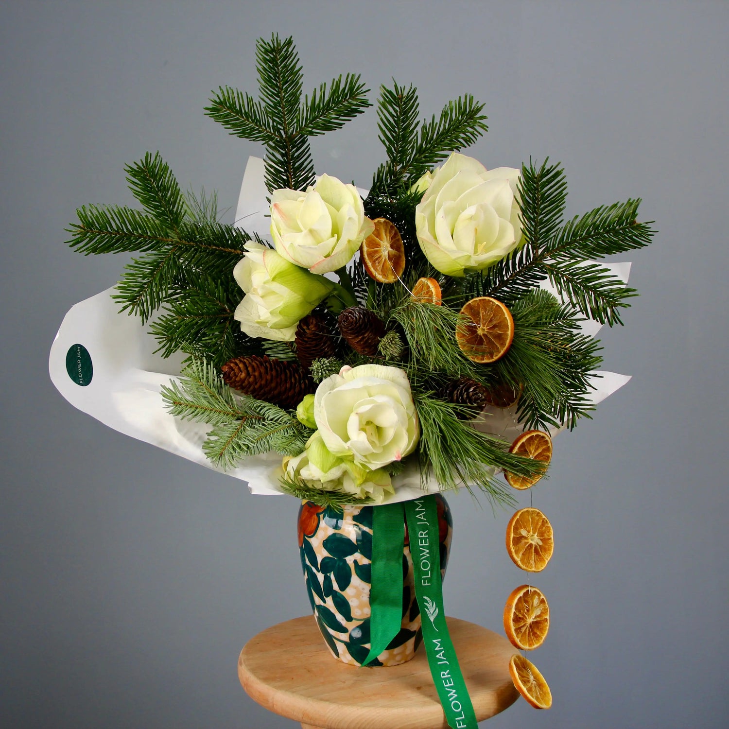 bouquet of spruce branches, white flowers, and oranges