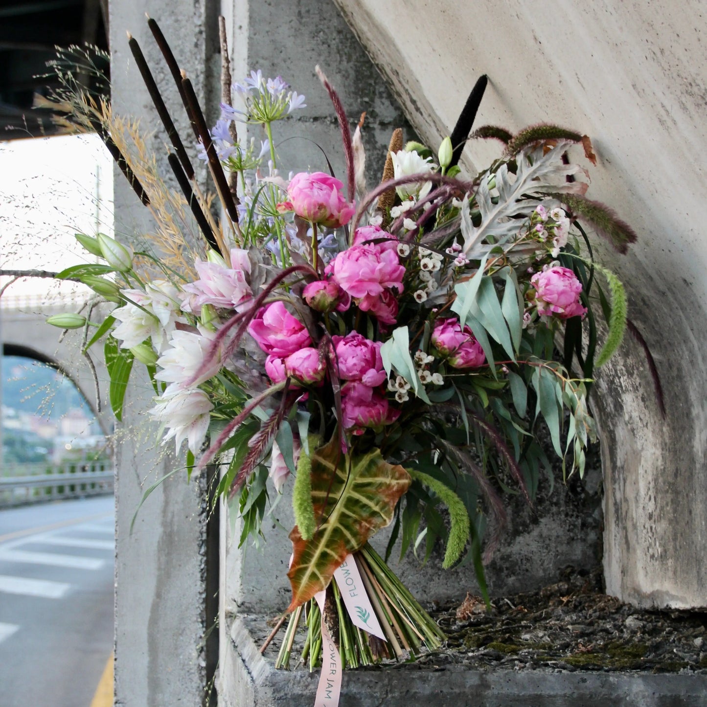 big bouquet with white an pink flowers with a lot of greenery