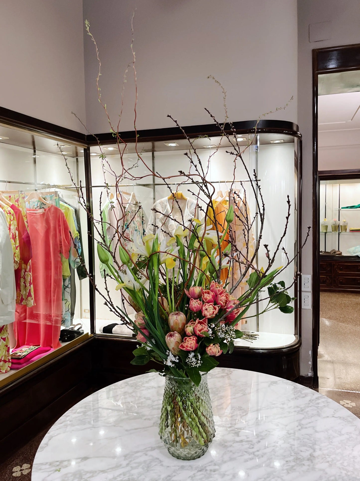 colorful floweres and magnolia branch in a vase