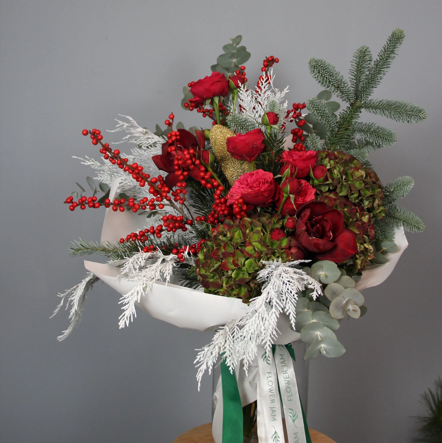 bouquet of red roses and spruce branches in a box