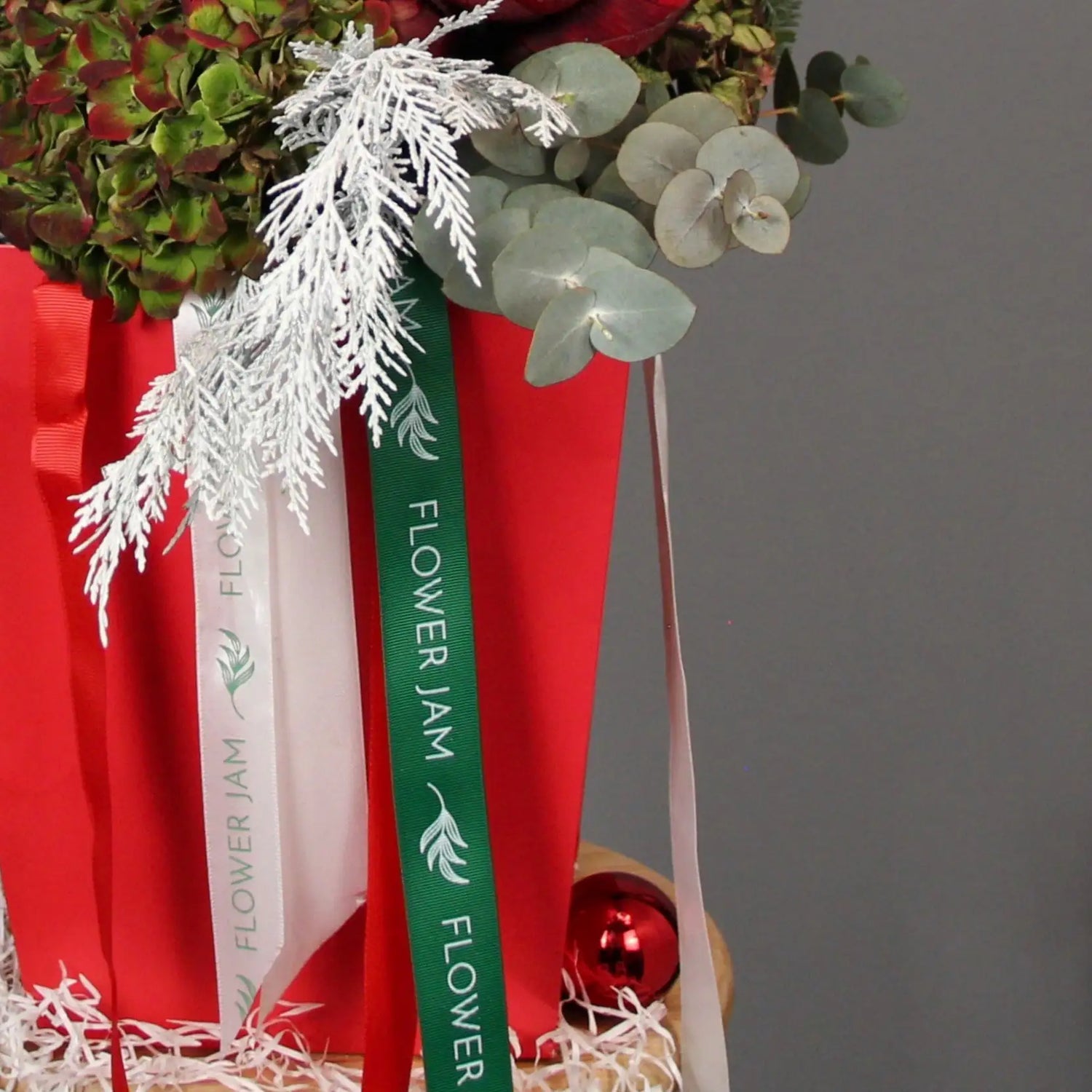 bouquet of red roses and spruce branches in a box