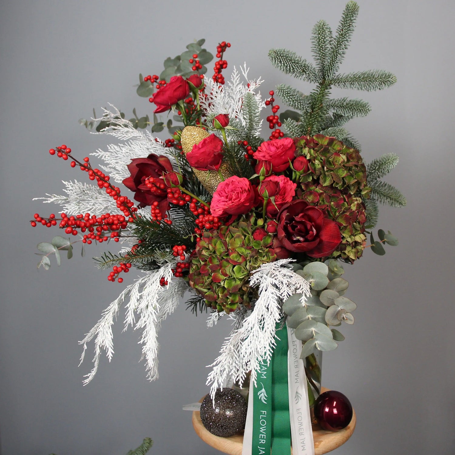 bouquet of red roses and spruce branches in a box