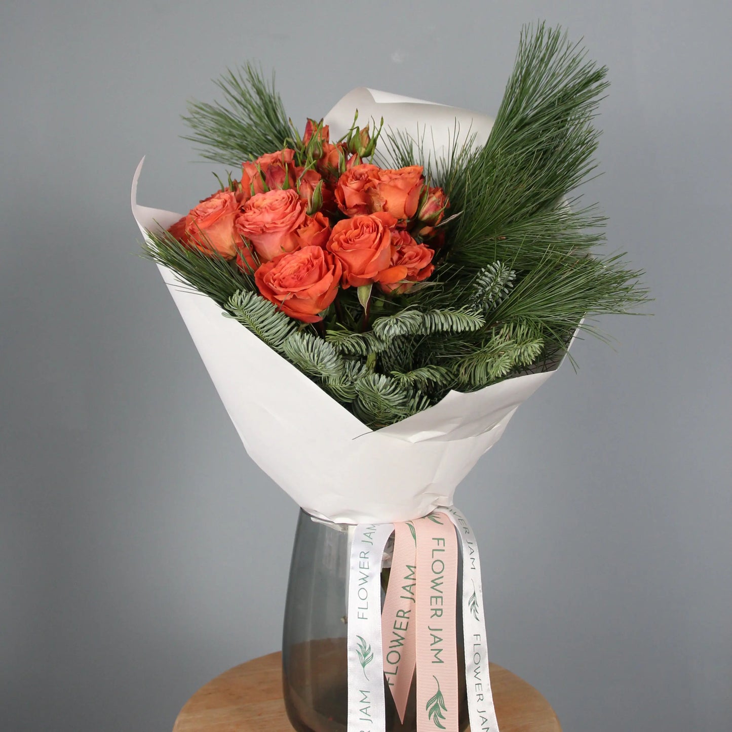 Orange roses and spruce branches bouquet  Bouquet of Flowers