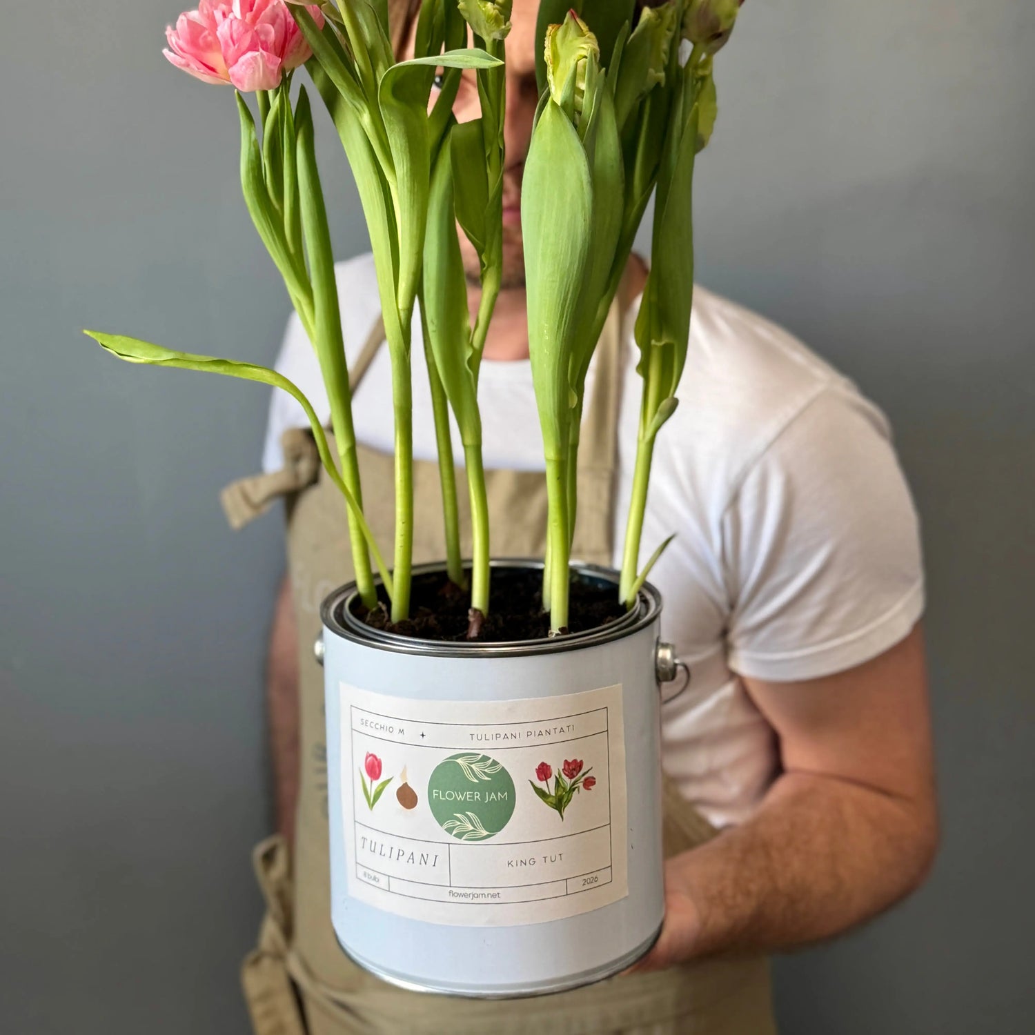 Man holding paint can repurpused as a flower pot