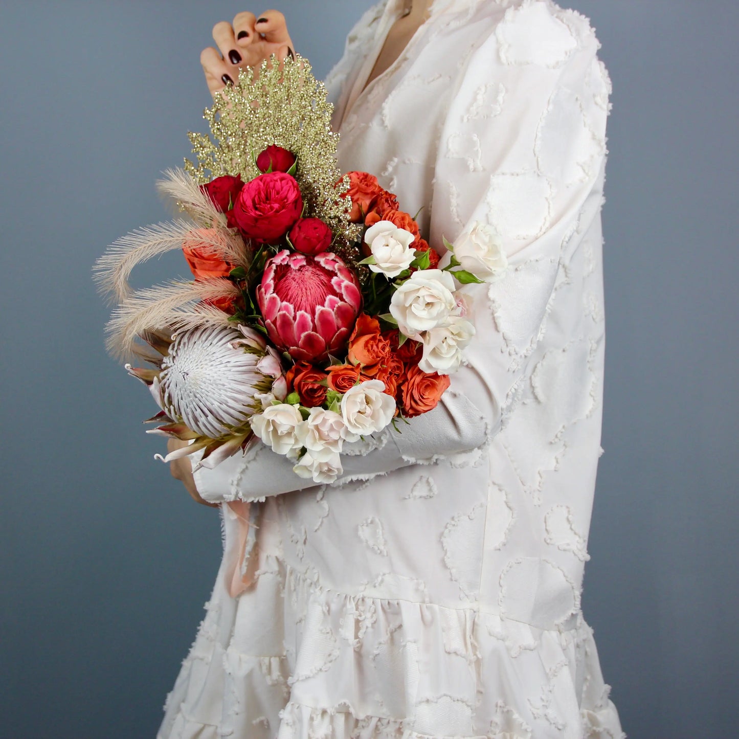 flower arrangement out of red, orange and white flowers