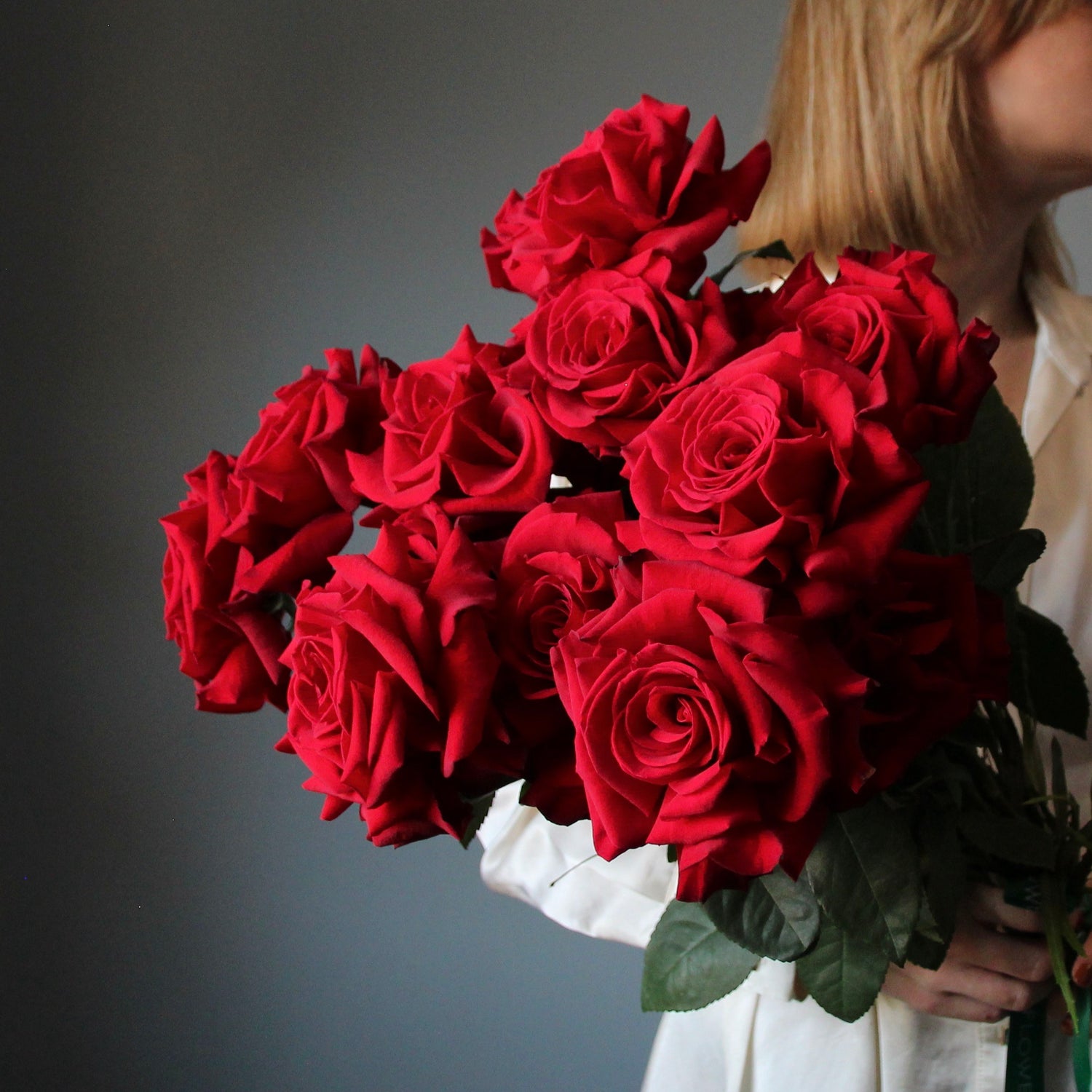 blonde girl with boquet of red roses from italian shopping Bouquet of Flowers