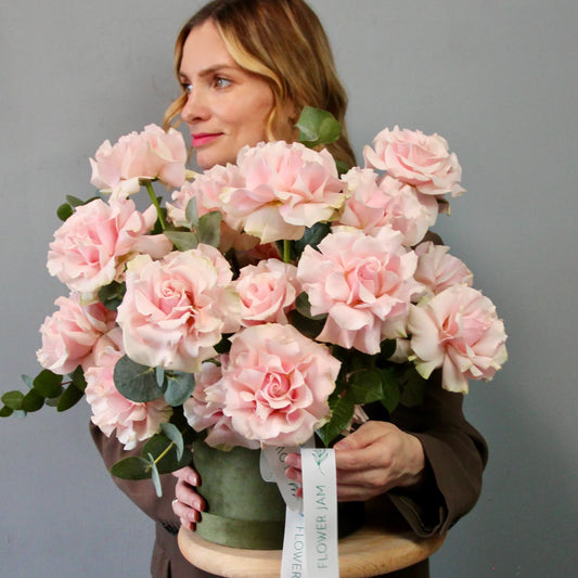 pink roses in a green box