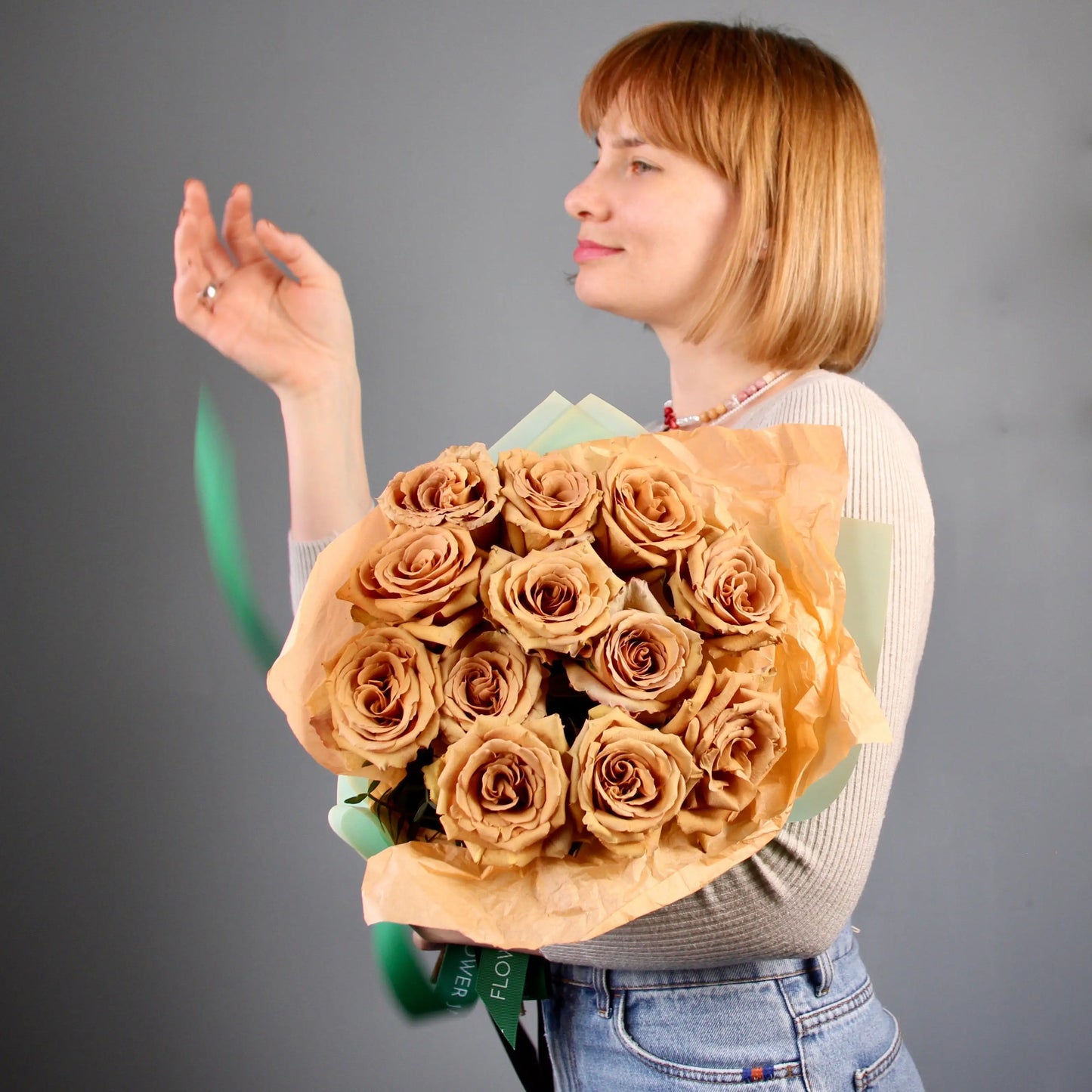 woman holding a bouquet of golden roses