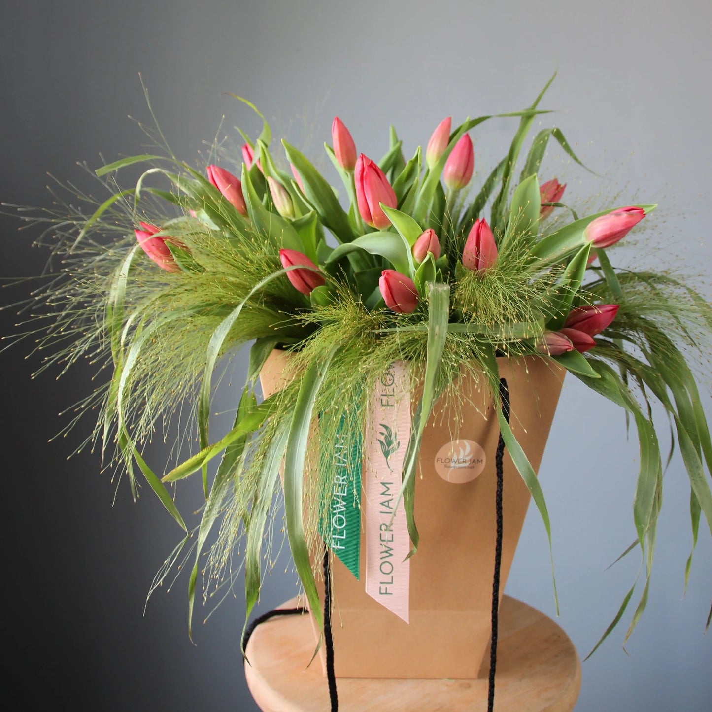 a big beautiful bouquet of pink tulips and greenery