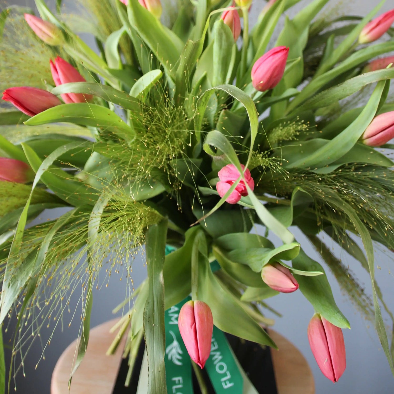 a big beautiful bouquet of pink tulips and greenery