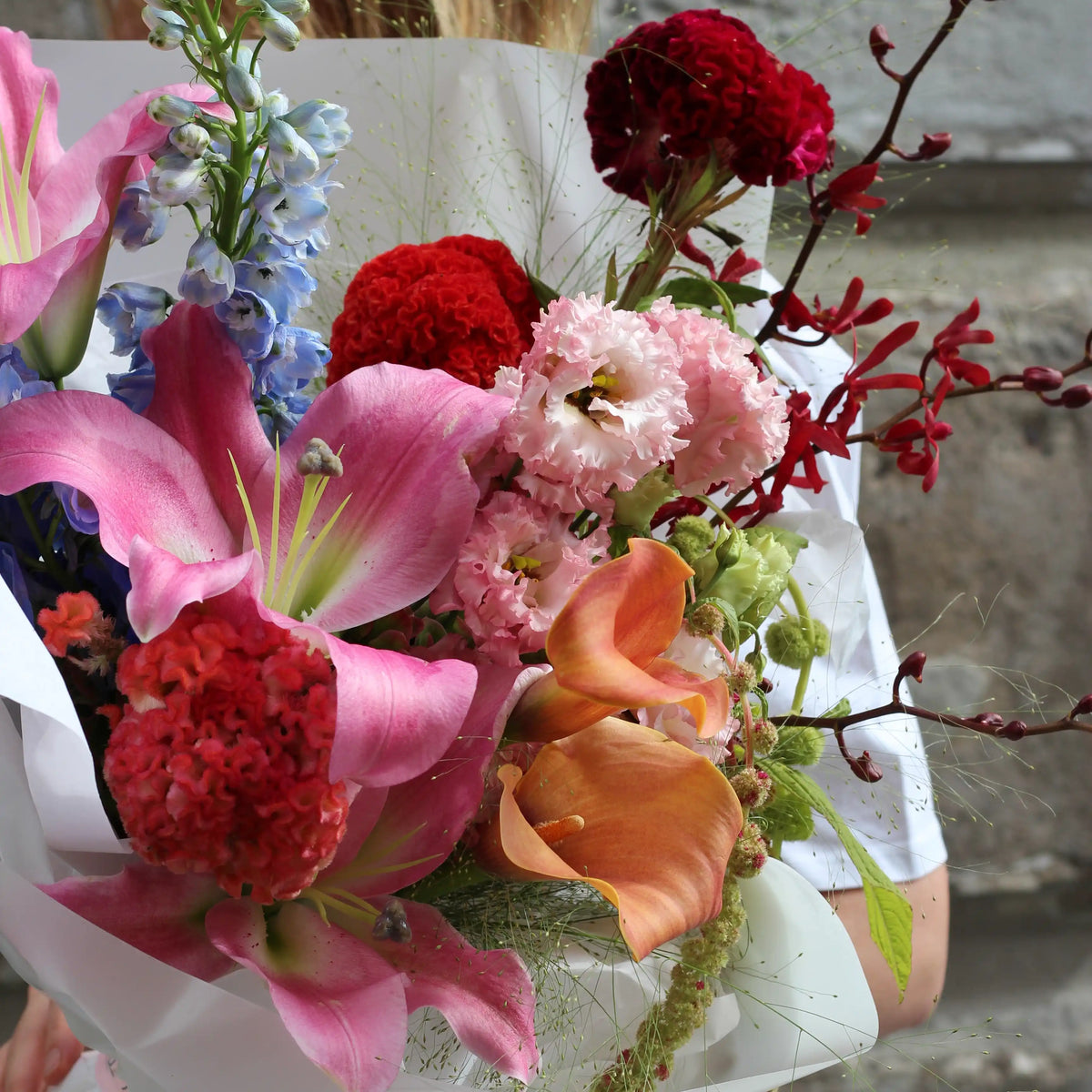 Close up on pink lisianthus, orange calla and pink lilies