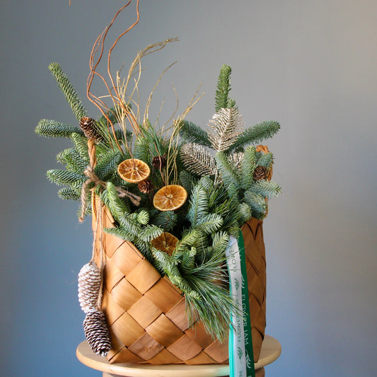 Christmas composition in a basket Flowers in a basket